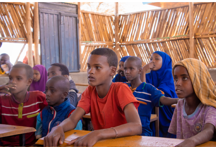 A teacher with students in an AID-supported classroom